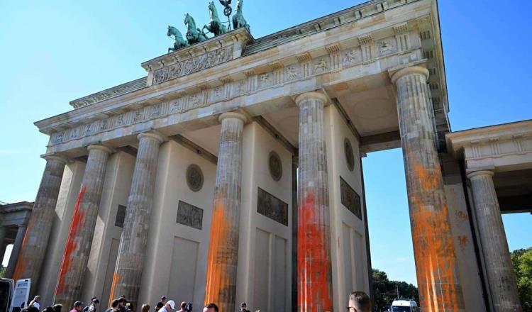 Activistas pintan Puerta de Brandeburgo en Berlín durante protesta